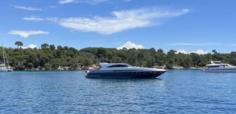 Luxury yacht in pristine waters in Cannes Lerins Islands during a sunny day with a guest enjoying water toys