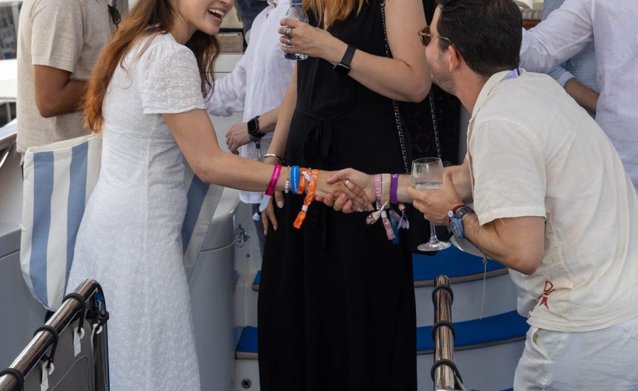 Guests shaking hands on the deck of a yacht during a congress in Cannes