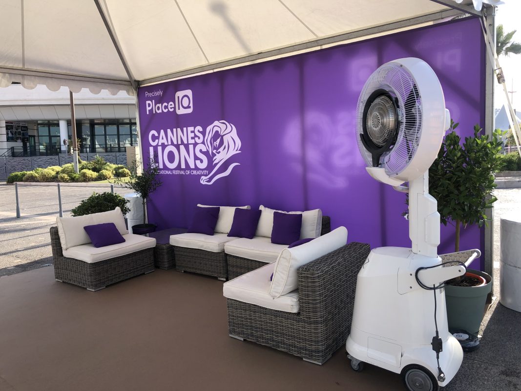 Branded lounge with sofas and a purple wall on a yacht deck during Cannes Lions