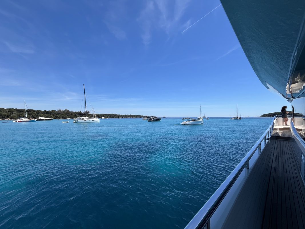 View from the deck of a yacht anchored near the Lerins Islands with sailboats in the bay