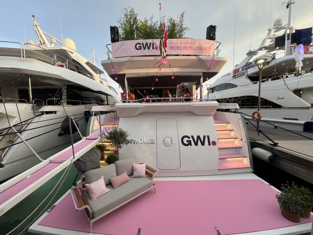 Stern of a charter yacht with a pink lounge deck moored at the quay in Cannes