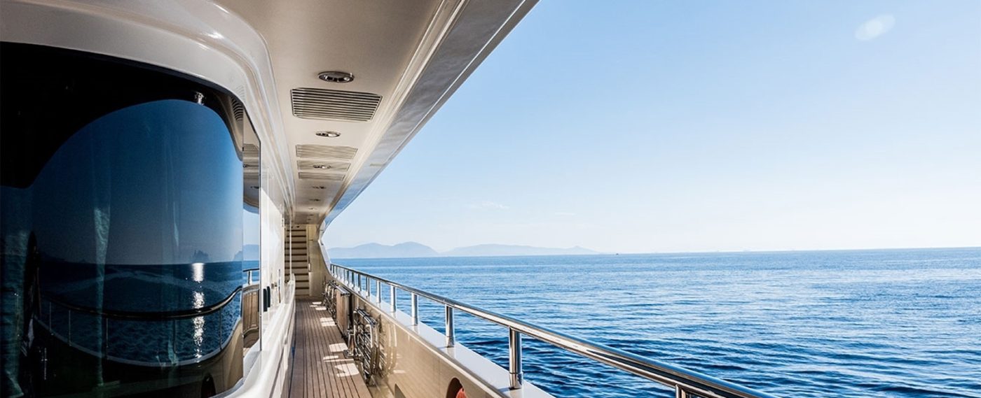 Side deck of a yacht cruising on a calm blue sea