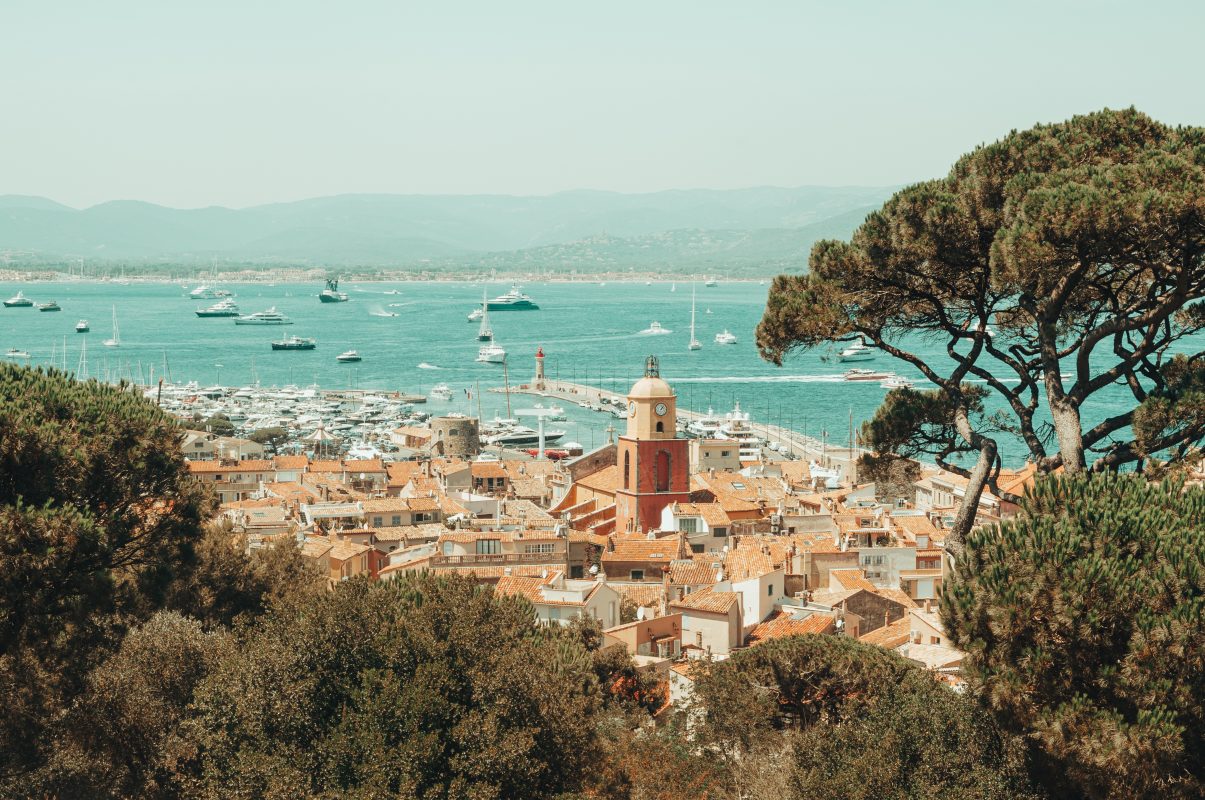 View over the roofs and bell tower of Saint-Tropez, with the harbour and the bay behind